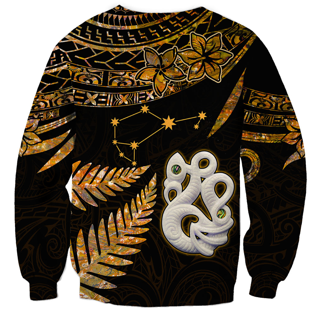 Unisex gold and black Maori sweatshirt with manaia face and fern leaf pattern