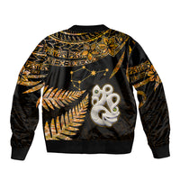 Bomber jacket with gold fern and star motifs, black body, ribbed hem, back emblem graphic