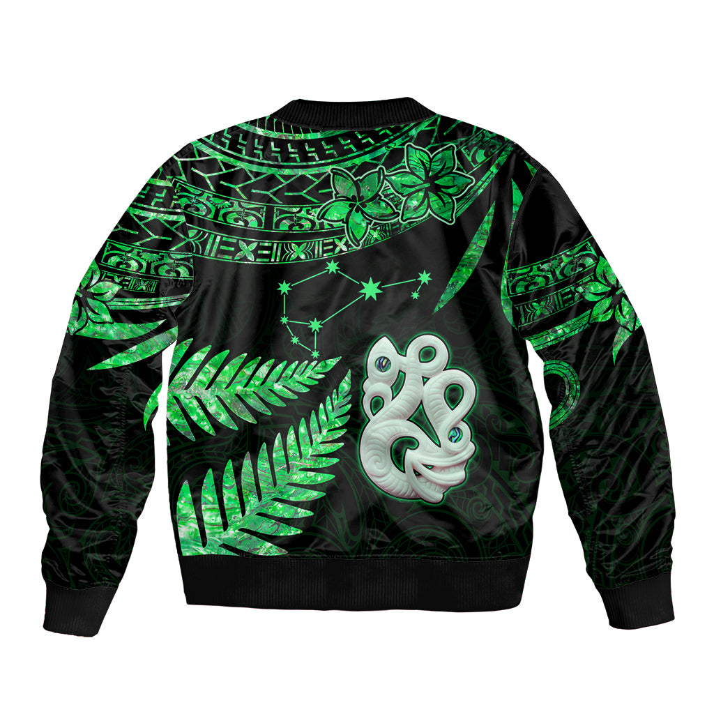 Green-and-black bomber jacket back view with fern and star patterns