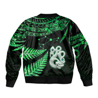 Green and black bomber jacket with zipper, ribbed hem, and leaf plus manaia chest graphic