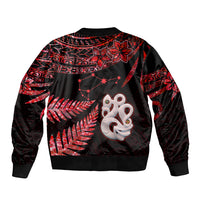 Unisex red-and-black bomber jacket back, red fern-and-manaia graphic, ribbed hem