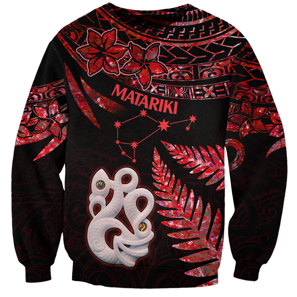Unisex red-and-black sweatshirt with manaia face graphic and star accents