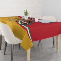 Red and yellow tablecloth with Sicilian flag-style emblem, set on a dining table