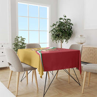 Red and gold tablecloth with Sicilian flag artwork on a dining table with chairs