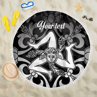 Round black beach blanket with white fringe and central face graphic with custom text