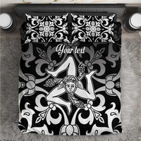 Black and white bedding set close-up showing baroque angel motif on duvet and pillowcases