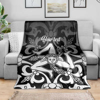 Personalized Sicily throw blanket on sofa, black-and-white Trinacria print with “Your text”