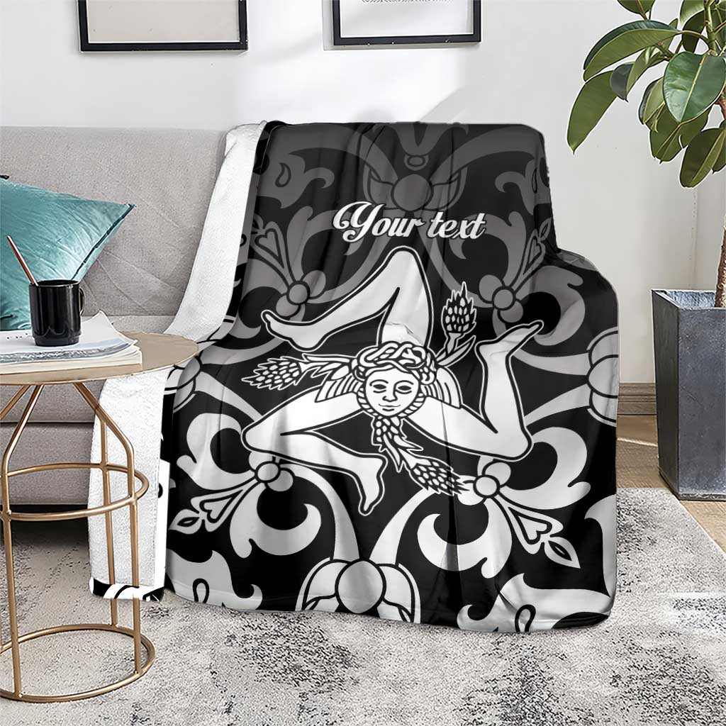Personalized Sicily blanket on gray rug, black-and-white Trinacria print with “Your text”