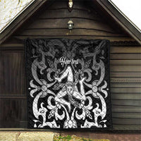 Black quilt blanket with geometric gray texture and central woman emblem, 'Your text'.