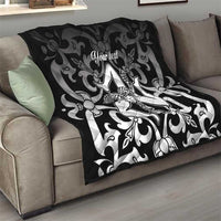 Black quilt blanket on sofa with gray floral swirl pattern and central woman graphic, 'Your text'.