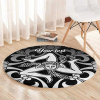 Black round carpet with white custom text and dancer motif on light wood floor