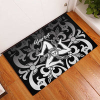Black rubber doormat with centered white angel motif and swirling damask, custom text