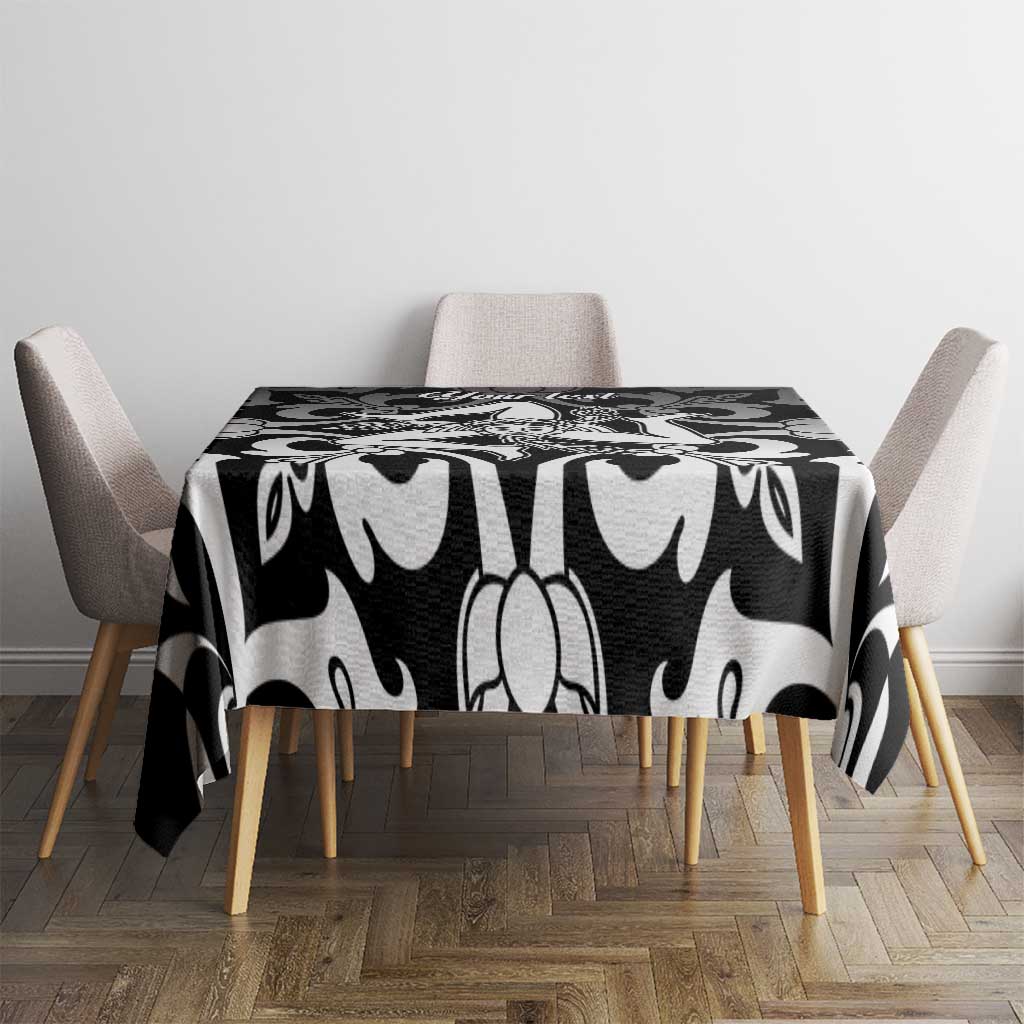 Black and white patterned tablecloth covering a square table
