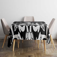 Black and white patterned tablecloth covering a square table