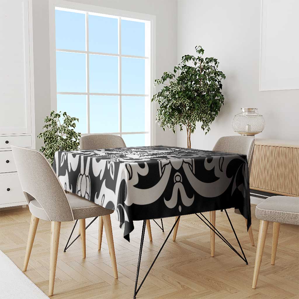 Black and white abstract tablecloth draped over a dining table