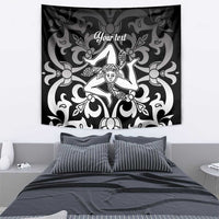 Black and white tapestry featuring central woman figure in baroque swirl design