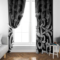 Black and white patterned window curtain panels framing a white window
