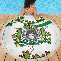 Round white cactus and lemon triskelion beach blanket with fringed edge on wooden deck