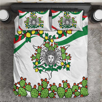 White bedding set with green cactus, lemons, and triskelion face medallion; two pillows