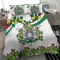 White bedding set with green cactus and lemon graphics, triskelion face center; two pillows
