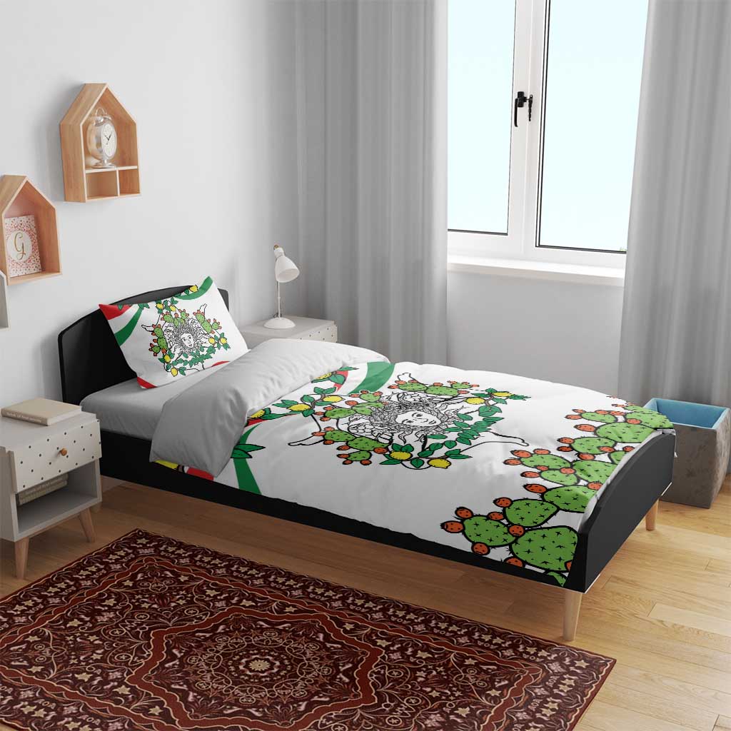 White bedding set with green cactus and lemon print on gray bed frame; two pillows