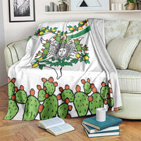White blanket with green cactus and orange-and-green cactus pattern, with lemon accents and motif.
