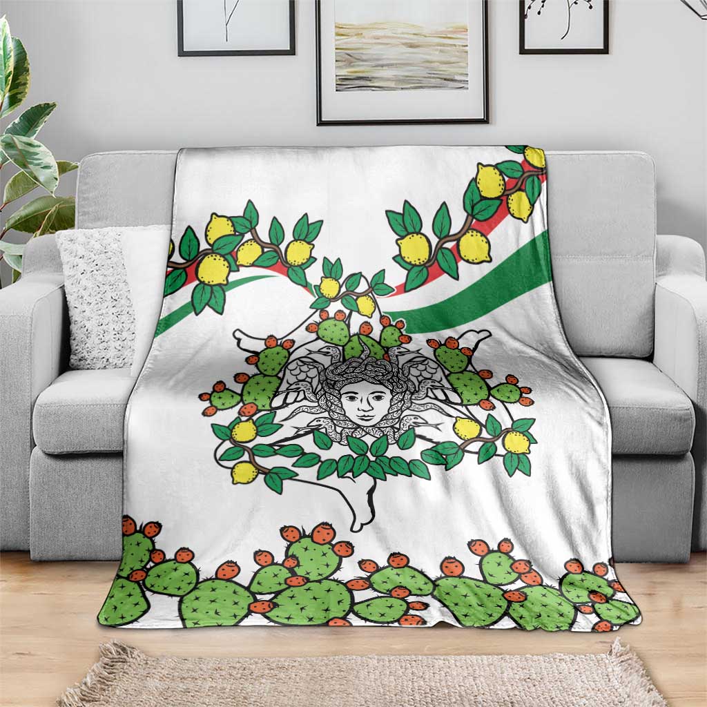 White blanket on sofa with cactus and lemon branches and central woman face graphic.