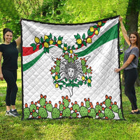 White quilt with green and red bands and cactus-lemon triskelion face pattern