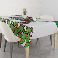 White tablecloth with cactus print on dining table, draped corner detail