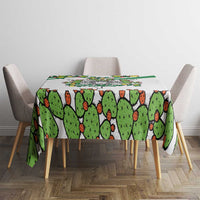 White tablecloth with cactus pattern across dining table, green border