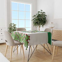 White tablecloth with cactus print and green stripe on dining table