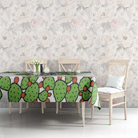 White tablecloth with cactus pattern on long dining table, green-edged hem