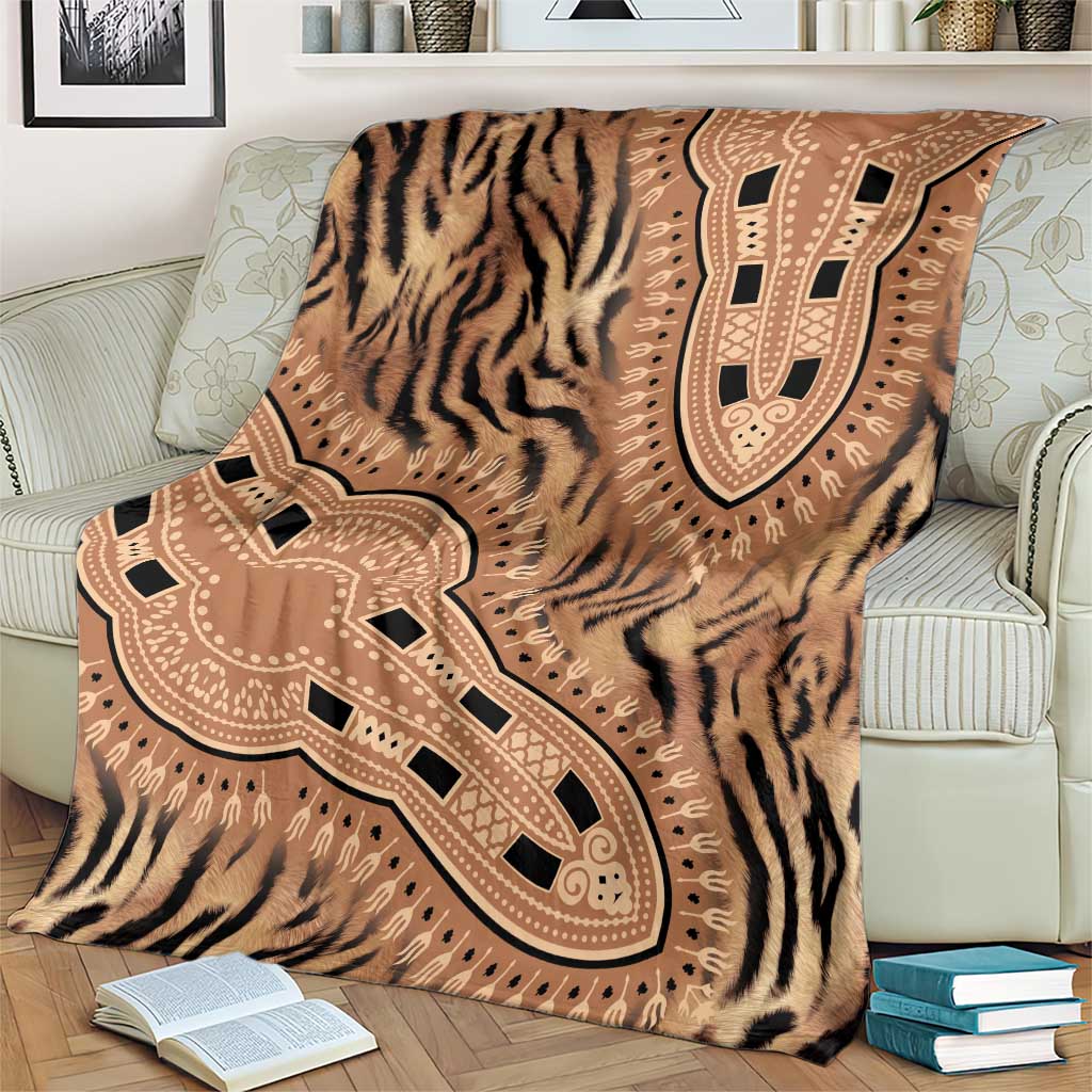 Brown and beige tiger-striped blanket with large tribal medallion graphic, spread on sofa