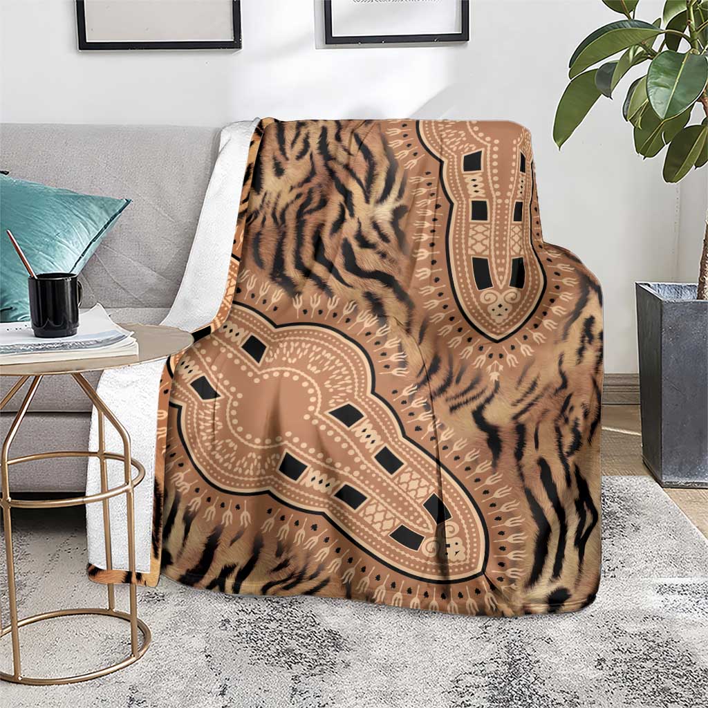 Brown tiger-striped blanket with ornate tribal medallion motif, draped over sofa arm