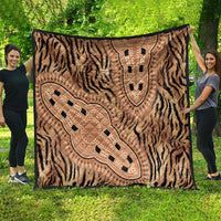 Beige zebra and tribal motif quilt laid on grass