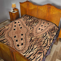 Beige quilt with zebra print and large medallion on wooden bed