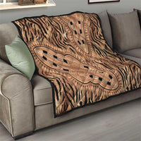 Beige zebra stripe quilt with large tan ornamental panel on sofa