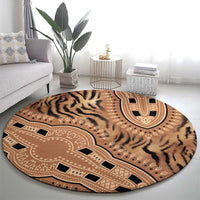 Round tiger-stripe and tribal medallion rug on light floor, beige and black