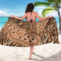 Tiger-print sarong with central tribal motif and border pattern in beige and dark brown