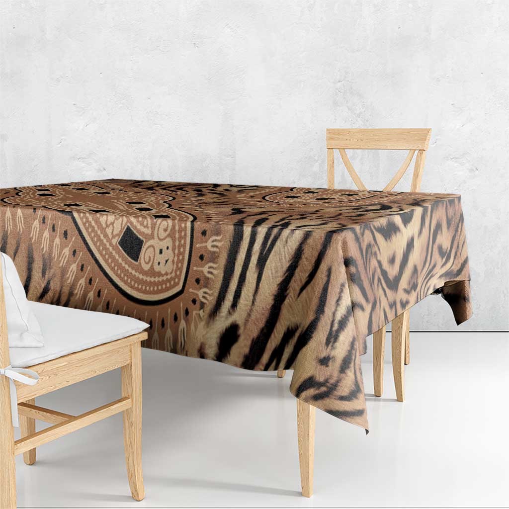 Beige and black tiger-striped tribal print tablecloth draped over bench table