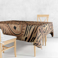 Beige and black tiger-striped tribal print tablecloth draped over bench table