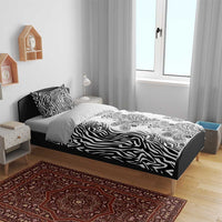 Black and white bedding set with zebra stripes and paisley floral motif on duvet cover