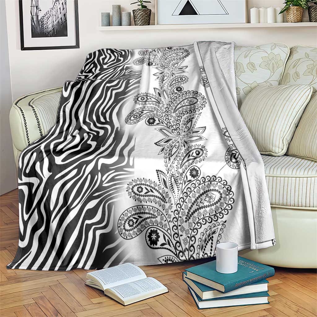 Black-and-white zebra and paisley tribal pattern blanket, draped over sofa back