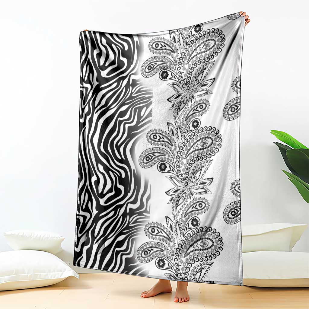Black-and-white zebra and paisley tribal blanket, shown hanging over bed edge