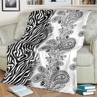 Black-and-white zebra and paisley tribal blanket, draped on striped armchair