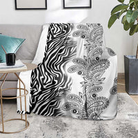 Black-and-white zebra and paisley tribal blanket, laid on living room rug