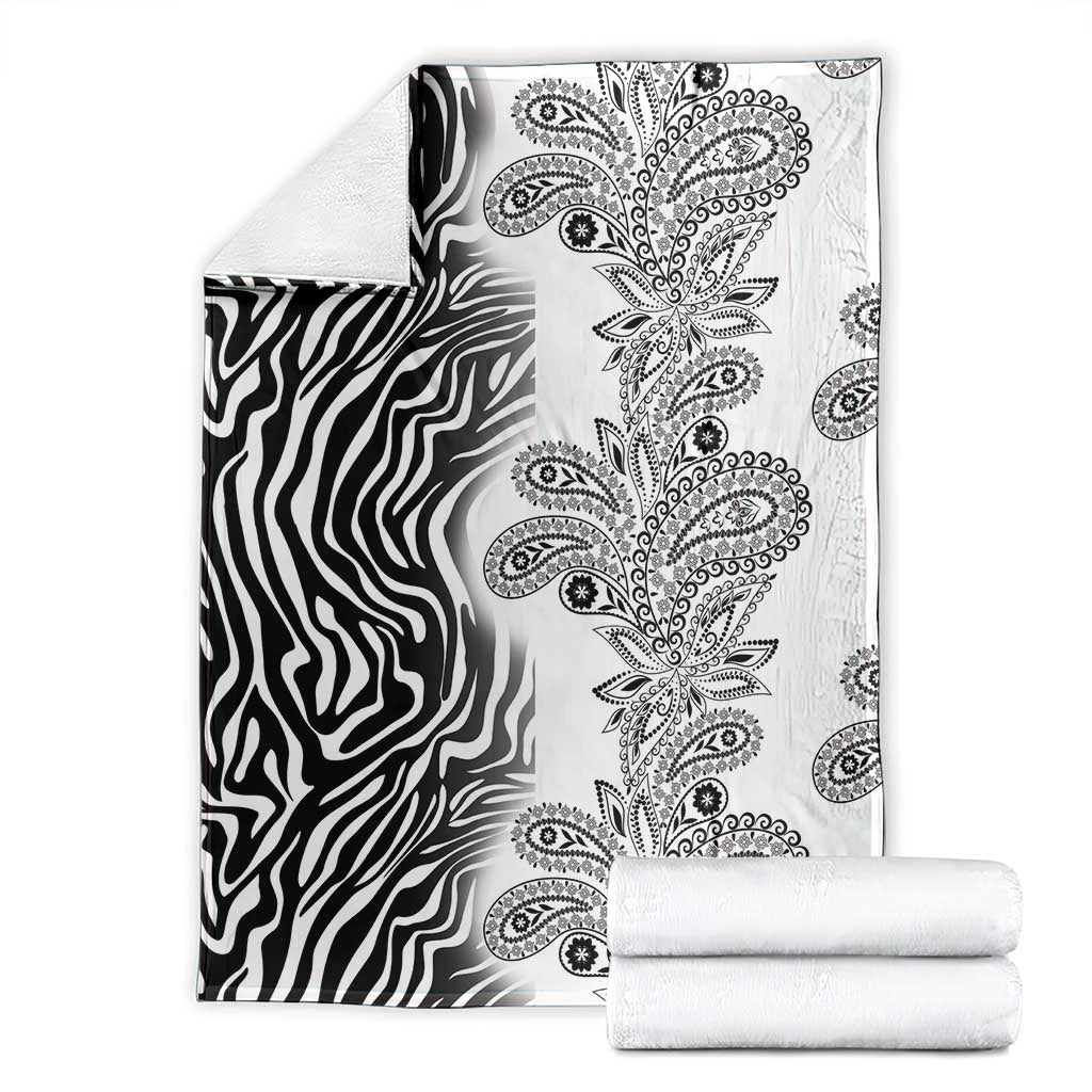 Black-and-white zebra and paisley tribal blanket, with folded matching fabric stack