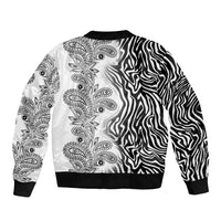 Unisex bomber jacket, white front with paisley print and black zebra stripe panel, ribbed hem