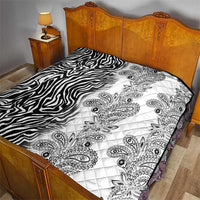 Black-and-white quilt with zebra stripe section and paisley medallion quilting details.