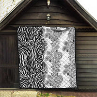 Black-and-white quilt with zebra stripe left panel and paisley print right panel.